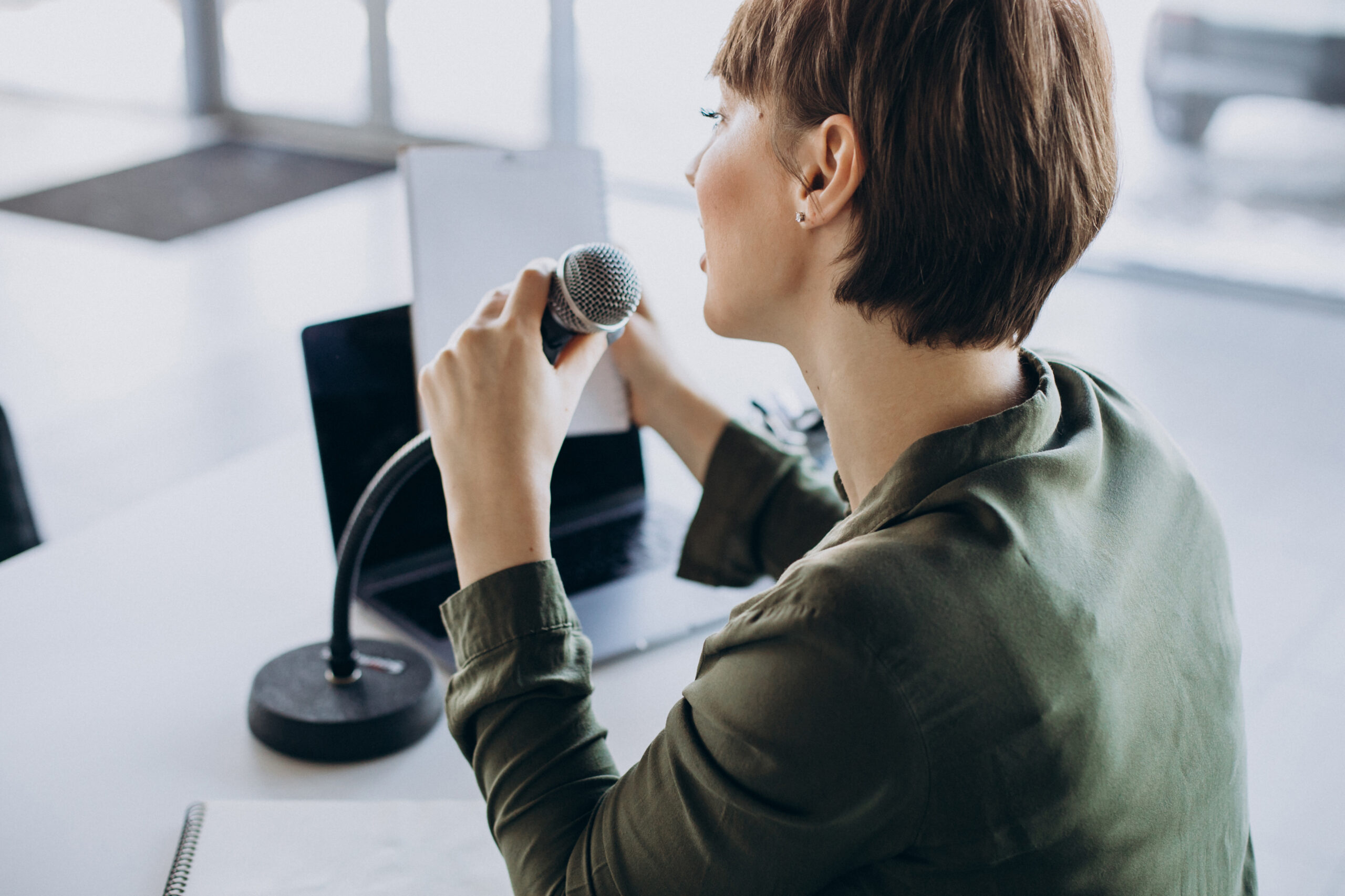 Young woman recording voice acting at studio